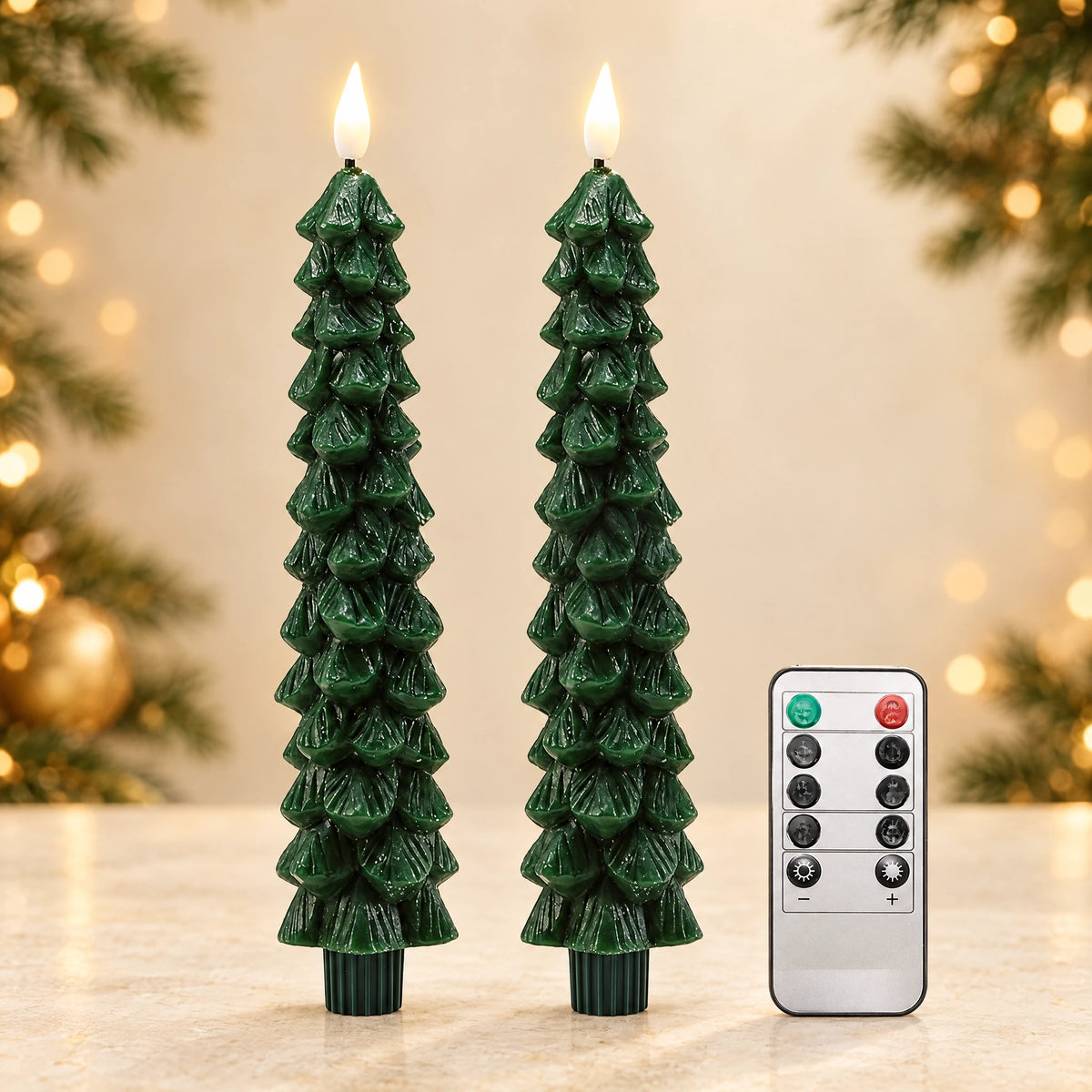 Two green tree-shaped LED taper candles with included white remote