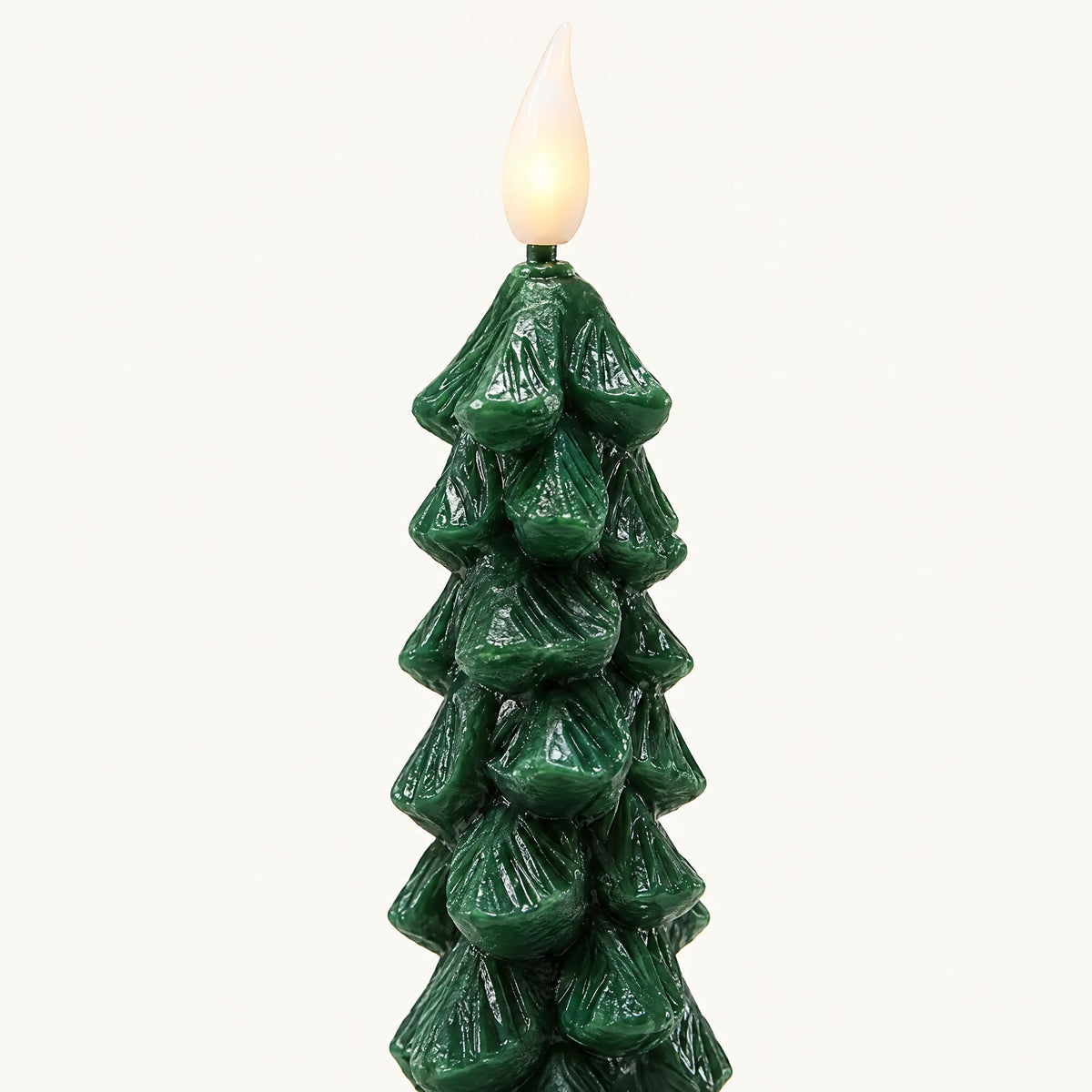 Close-up of green molded tree candle and LED flame tip