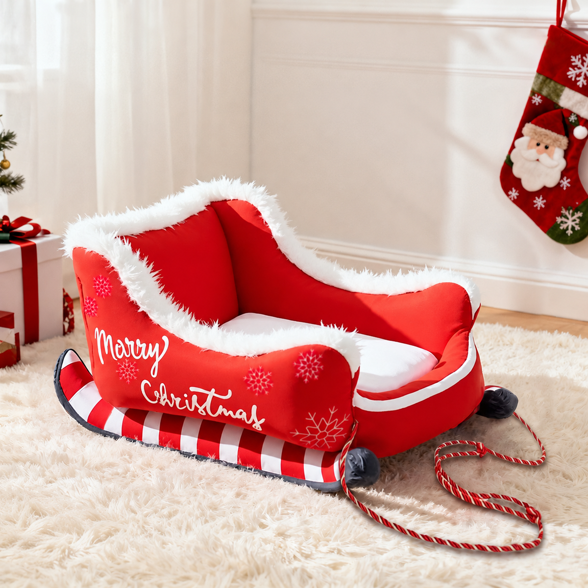 Red sleigh pet bed with white cushion and festive trim