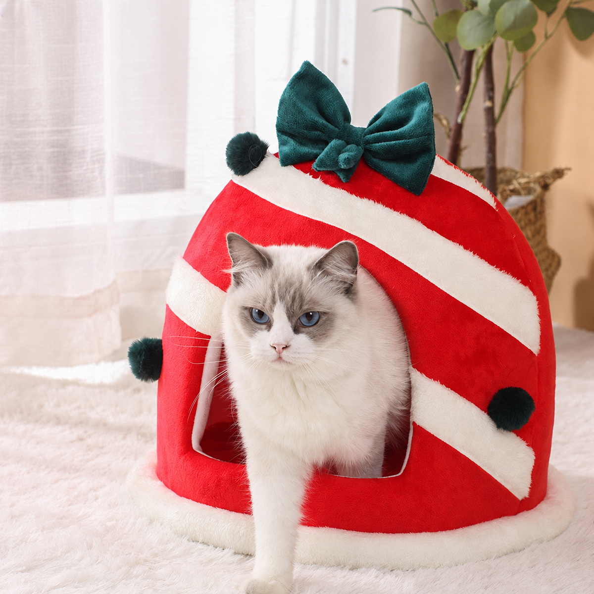 Round red and white Christmas pet house with green bow and a cat