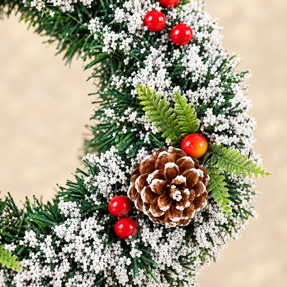 Close-up of frosted foliage, pinecone and berries on Christmas wreath